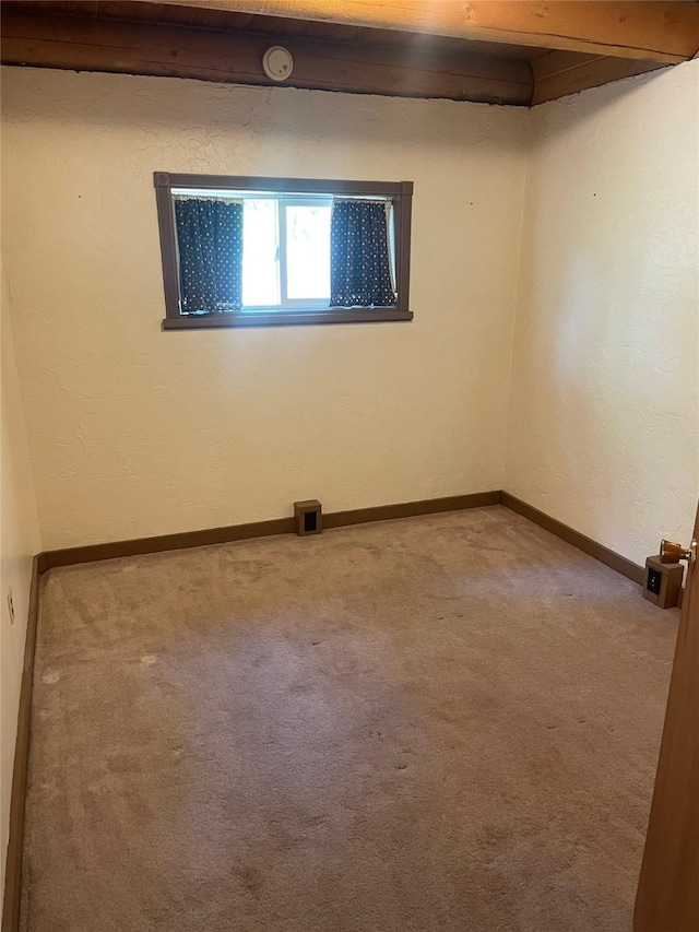 22550 Hill Rd, Clinton, MT 59825 - empty room featuring carpet floors, beam ceiling, and a smoke detector