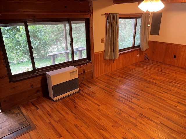 22550 Hill Rd, Clinton, MT 59825 - spare room featuring wood walls, a wainscoted wall, heating unit, healthy amount of natural light, and electric panel