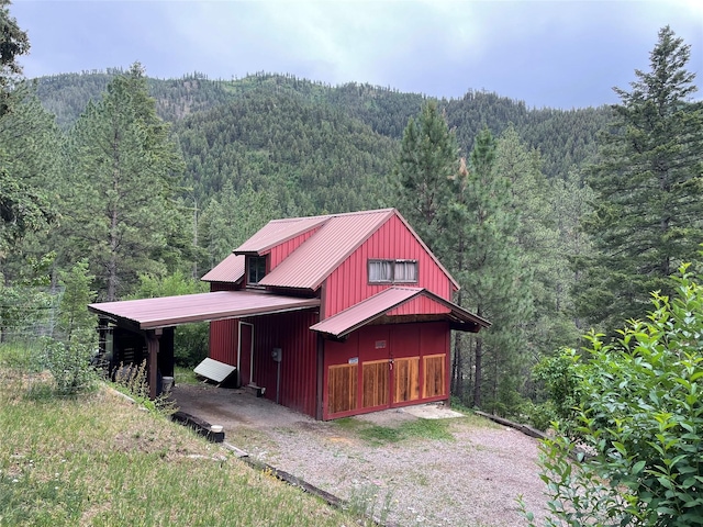 22550 Hill Rd, Clinton, MT 59825 - view of front facade with a view of trees and a metal roof