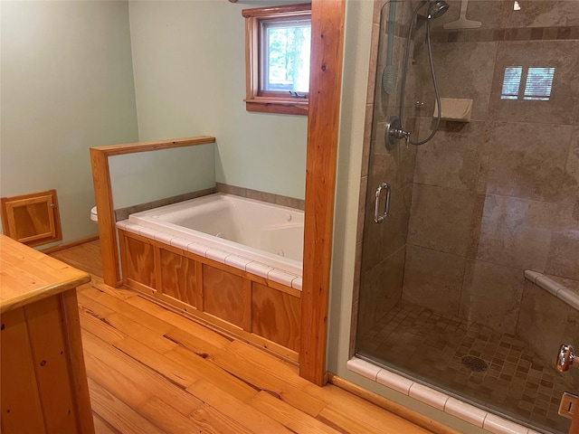 22550 Hill Rd, Clinton, MT 59825 - full bathroom with a garden tub, a stall shower, wood finished floors, and vanity