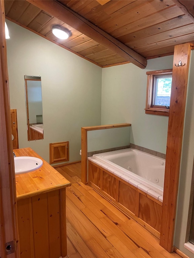 22550 Hill Rd, Clinton, MT 59825 - full bath featuring wood ceiling, a tub with jets, hardwood / wood-style flooring, and vanity