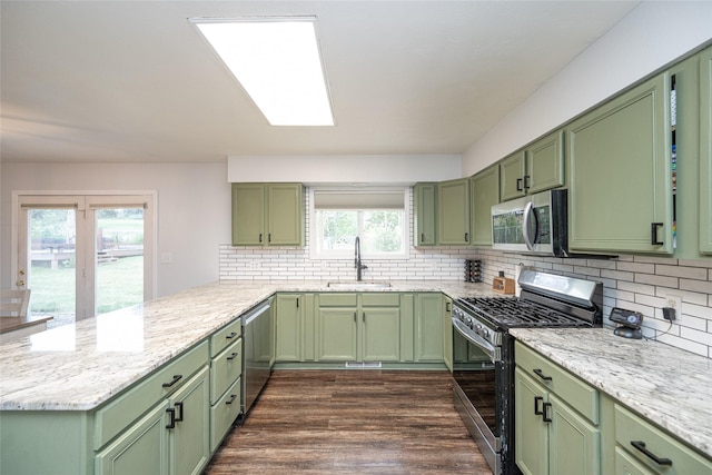 51 Konley Dr, Kalispell, MT 59901 - kitchen featuring green cabinetry, stainless steel appliances, a peninsula, and tasteful backsplash