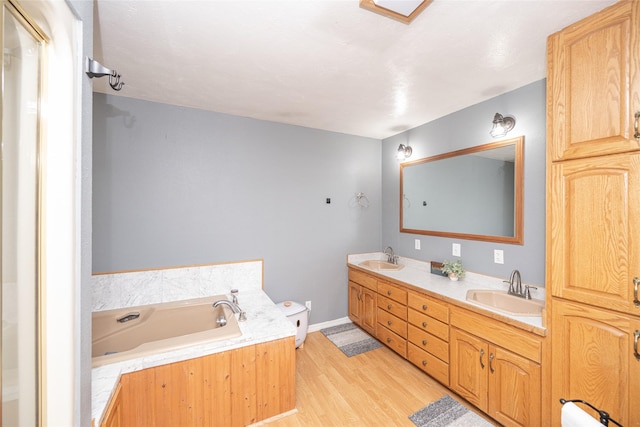 51 Konley Dr, Kalispell, MT 59901 - bathroom featuring a bath, double vanity, and wood finished floors
