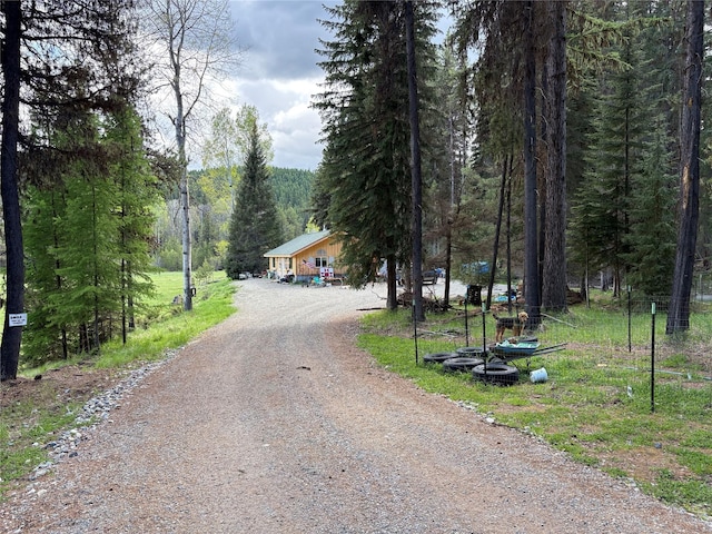 27687 Yaak River Rd, Troy, MT 59935 - view of dirt / gravel driveway featuring a wooded view