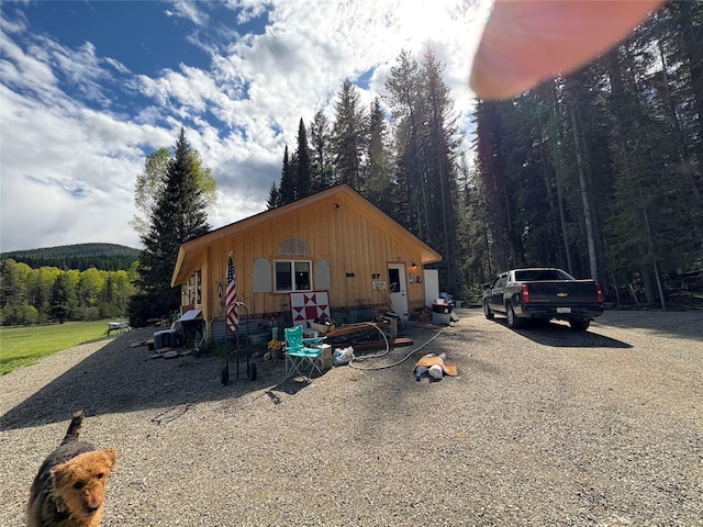 27687 Yaak River Rd, Troy, MT 59935 - view of front of house featuring a wooded view and board and batten siding
