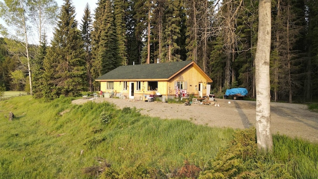 27687 Yaak River Rd, Troy, MT 59935 - view of front of property with a wooded view and roof with shingles