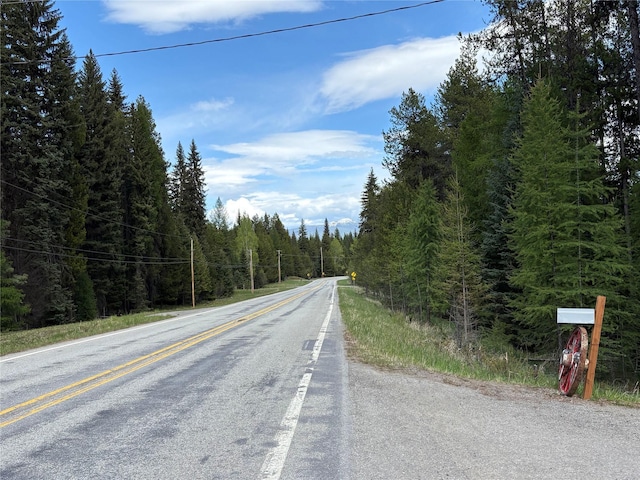 27687 Yaak River Rd, Troy, MT 59935 - view of asphalt road featuring a wooded view