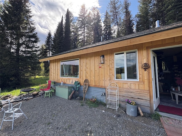 27687 Yaak River Rd, Troy, MT 59935 - view of home's exterior with board and batten siding and an outdoor fire pit