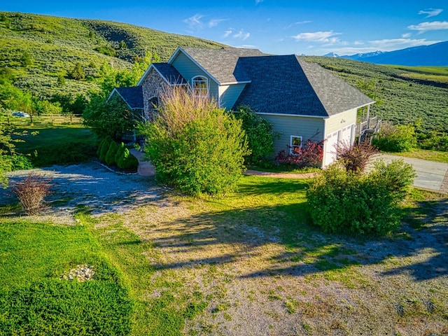 396 Wild Moose Springs Rd, Corvallis, MT 59828 - view of side of home featuring concrete driveway, a garage, and a yard
