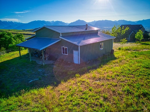 396 Wild Moose Springs Rd, Corvallis, MT 59828 - view of side of home with a metal roof and a mountain view