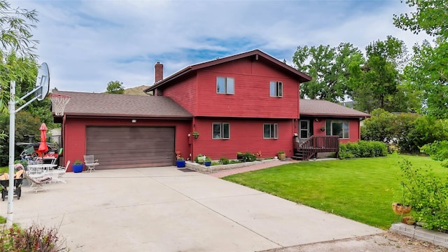 952 Chestnut Ave, Highwood, MT 59450 - split level home featuring a front lawn, an attached garage, a chimney, concrete driveway, and a shingled roof