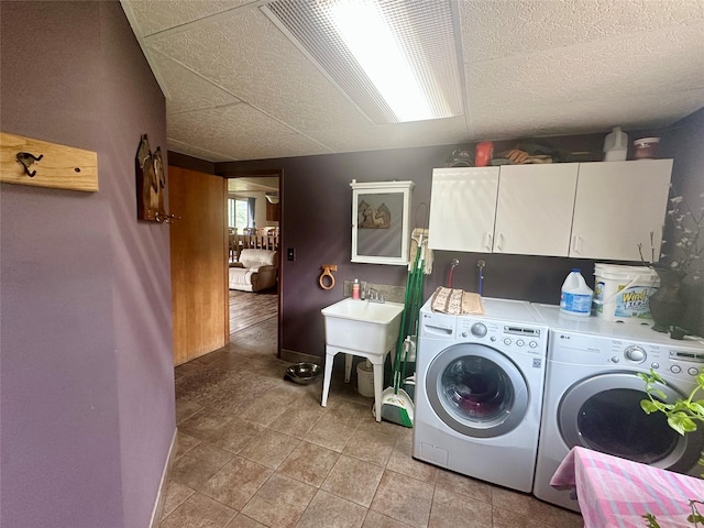 952 Chestnut Ave, Highwood, MT 59450 - laundry room featuring separate washer and dryer, cabinet space, and light tile patterned floors