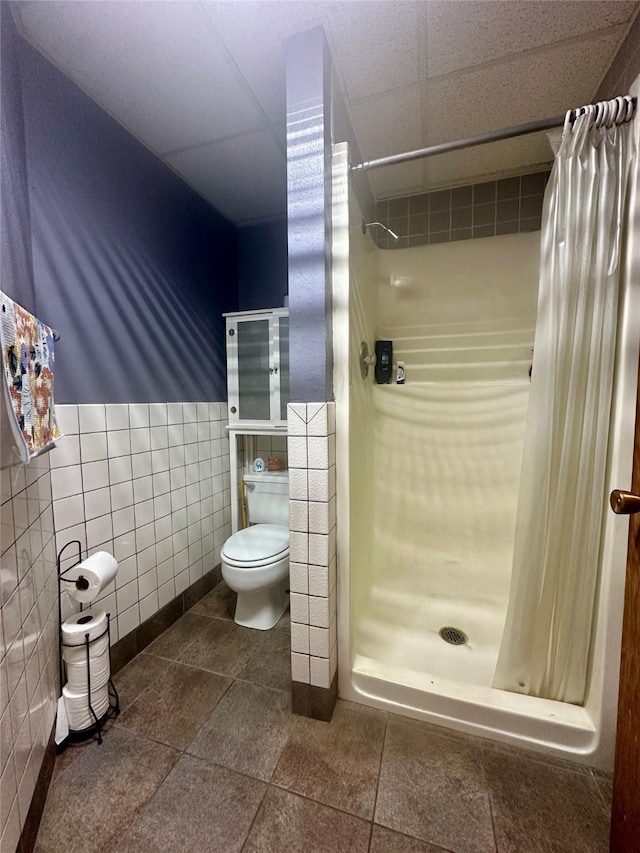 952 Chestnut Ave, Highwood, MT 59450 - bathroom with tile walls, a shower stall, wainscoting, and tile patterned flooring