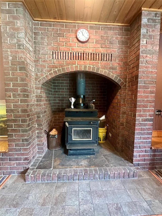 952 Chestnut Ave, Highwood, MT 59450 - detailed view of wooden ceiling, a wood stove, and brick wall