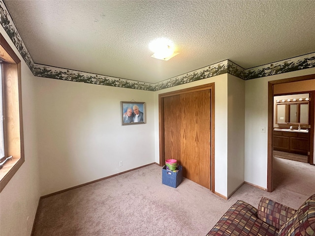 952 Chestnut Ave, Highwood, MT 59450 - unfurnished bedroom featuring carpet, a textured ceiling, and a closet