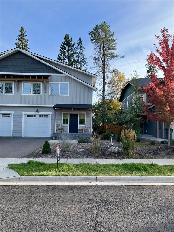 777 Aspen Grove St, Whitefish, MT 59937 - view of front of property featuring board and batten siding, a garage, driveway, and a porch
