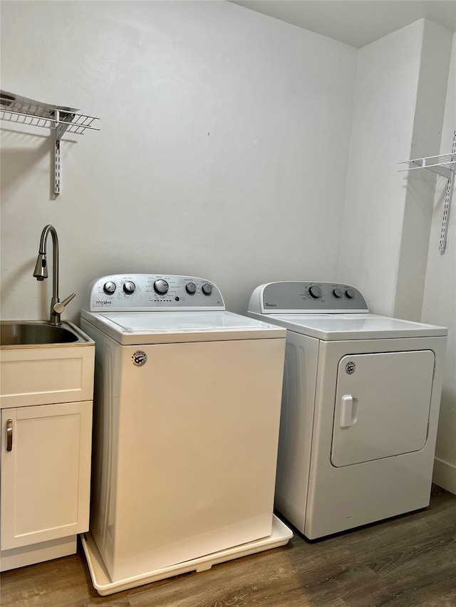 777 Aspen Grove St, Whitefish, MT 59937 - laundry room featuring independent washer and dryer, wood finished floors, and cabinet space