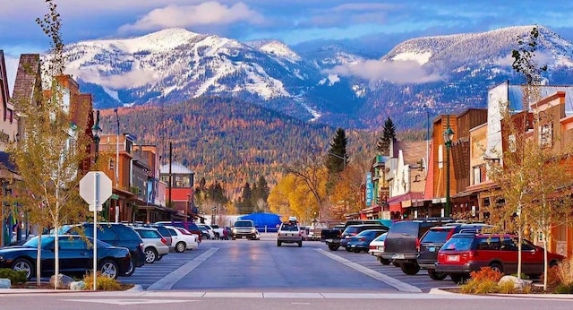 777 Aspen Grove St, Whitefish, MT 59937 - view of asphalt street with a mountain view, traffic signs, and curbs