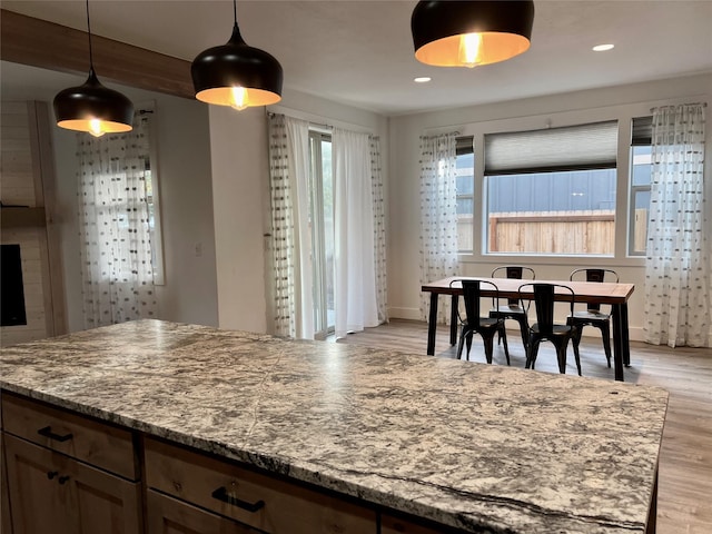 777 Aspen Grove St, Whitefish, MT 59937 - kitchen featuring light wood finished floors, pendant lighting, light stone countertops, and recessed lighting