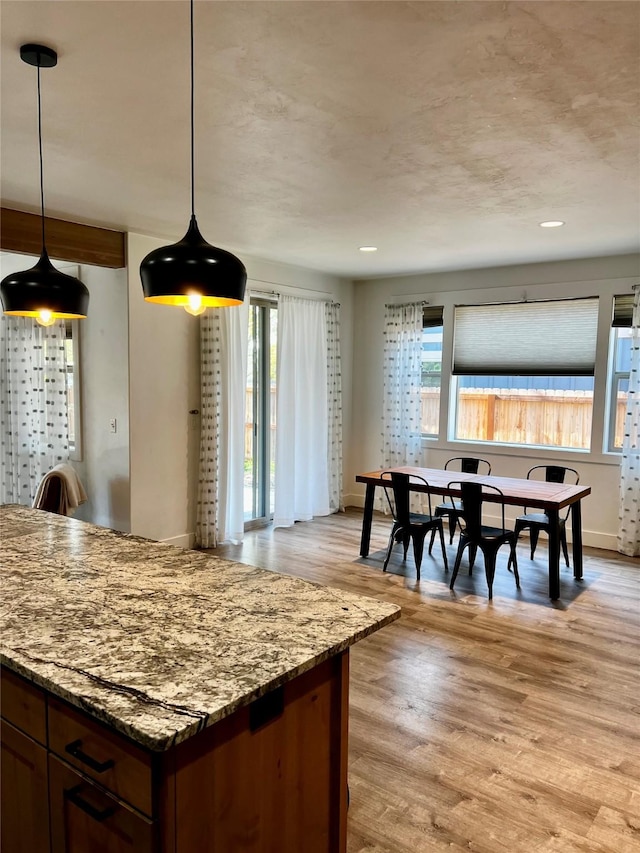 777 Aspen Grove St, Whitefish, MT 59937 - kitchen featuring light wood finished floors, light stone counters, decorative light fixtures, and recessed lighting