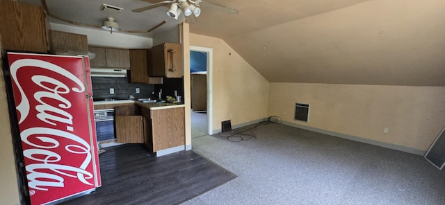 915 3rd Ave SW, Great Falls, MT 59404 - kitchen with under cabinet range hood, vaulted ceiling, ceiling fan, light countertops, and brown cabinets