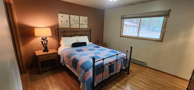 9 Cross Ln, Plains, MT 59859 - bedroom with wood finished floors and a baseboard heating unit