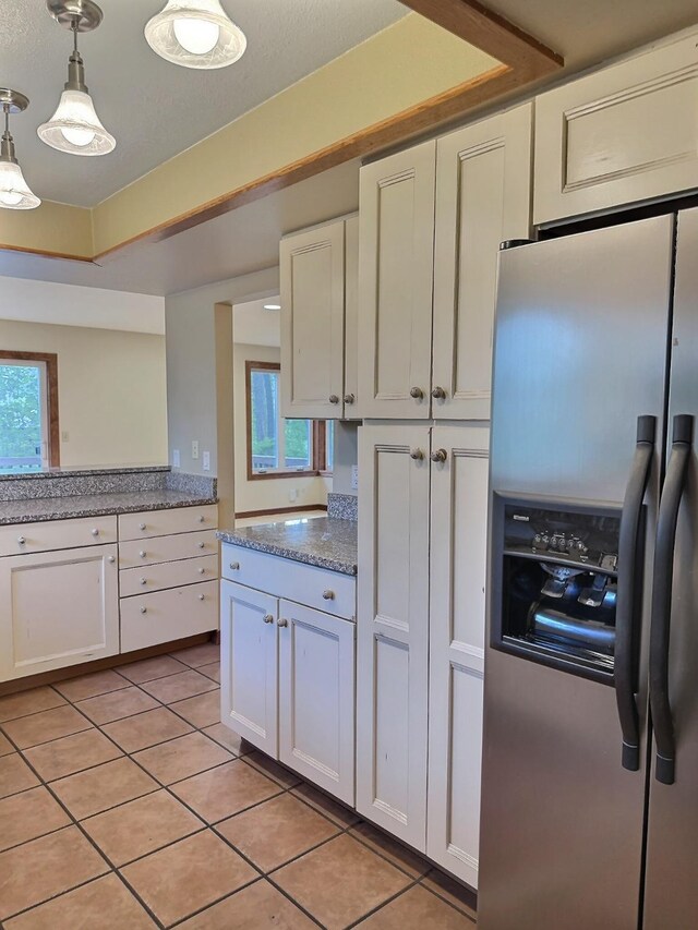 251 Elk Trl, Whitefish, MT 59937 - kitchen featuring stainless steel refrigerator with ice dispenser, light tile patterned flooring, white cabinets, decorative light fixtures, and light stone countertops