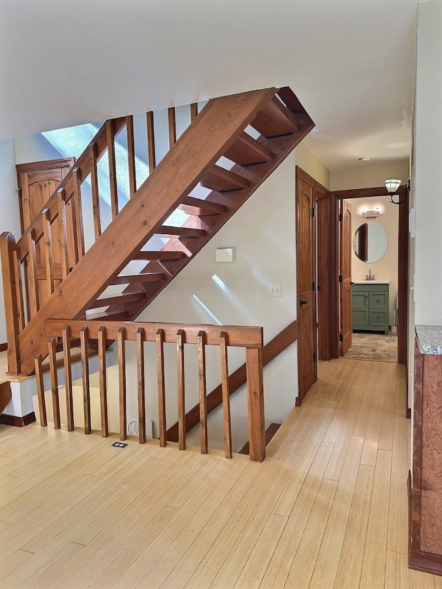 251 Elk Trl, Whitefish, MT 59937 - staircase featuring hardwood / wood-style floors and a chandelier
