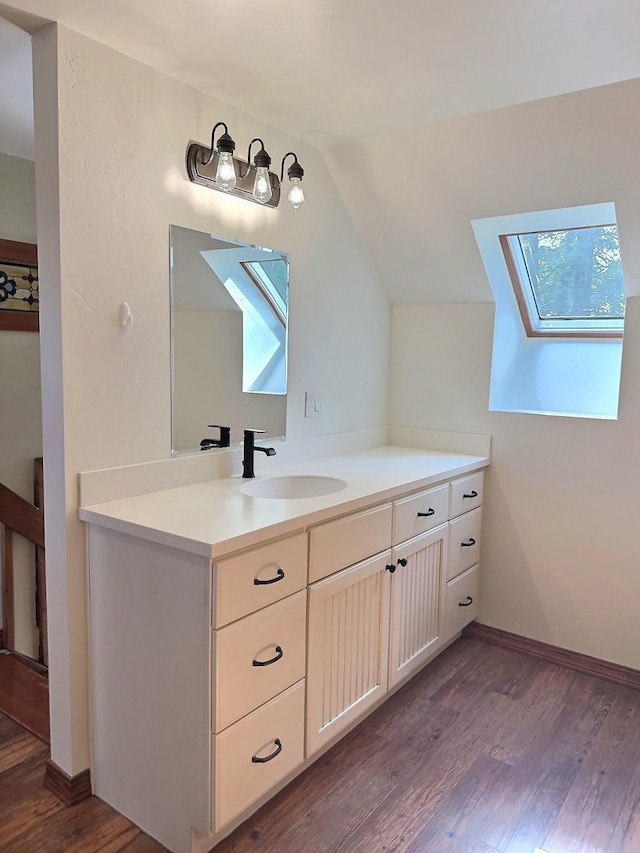 251 Elk Trl, Whitefish, MT 59937 - bathroom featuring a skylight, wood finished floors, vanity, and lofted ceiling