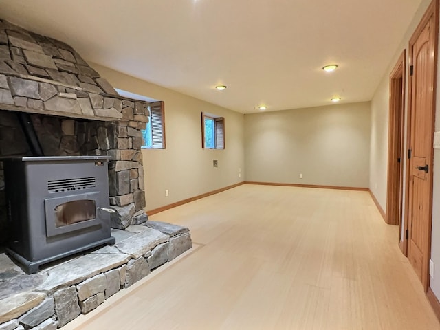 251 Elk Trl, Whitefish, MT 59937 - unfurnished living room featuring a wood stove and light wood-type flooring