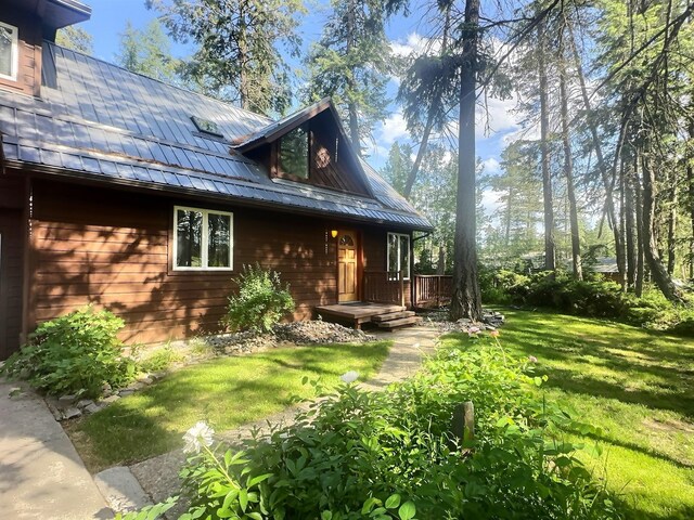 251 Elk Trl, Whitefish, MT 59937 - rear view of property featuring a standing seam roof, a metal roof, and a lawn