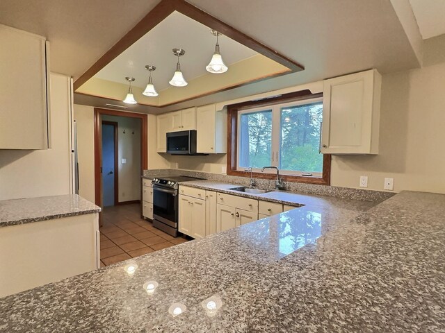 251 Elk Trl, Whitefish, MT 59937 - kitchen with appliances with stainless steel finishes, a tray ceiling, white cabinetry, dark stone counters, and light tile patterned floors