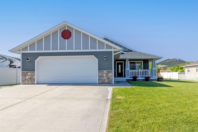 341 Northgate Loop, Helena, MT 59602 - craftsman house featuring stone siding, a porch, board and batten siding, and concrete driveway
