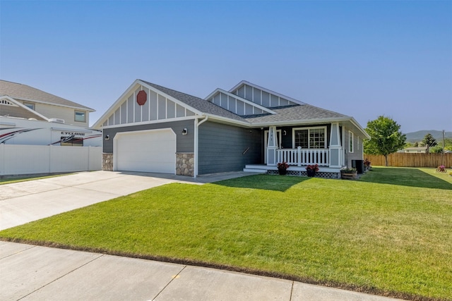 341 Northgate Loop, Helena, MT 59602 - view of front facade with board and batten siding, a porch, an attached garage, driveway, and stone siding