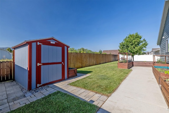 341 Northgate Loop, Helena, MT 59602 - fenced backyard featuring a garden and a storage unit