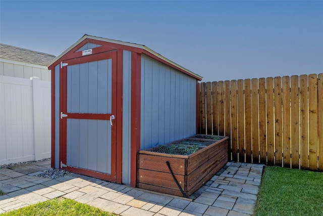 341 Northgate Loop, Helena, MT 59602 - view of shed with a fenced backyard and a garden