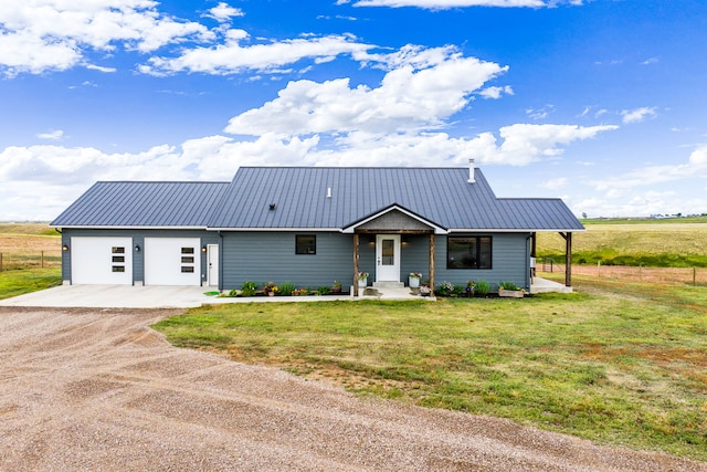 44 Kamloops Rd, Power, MT 59468 - view of front of home featuring dirt driveway, a front yard, a metal roof, and an attached garage