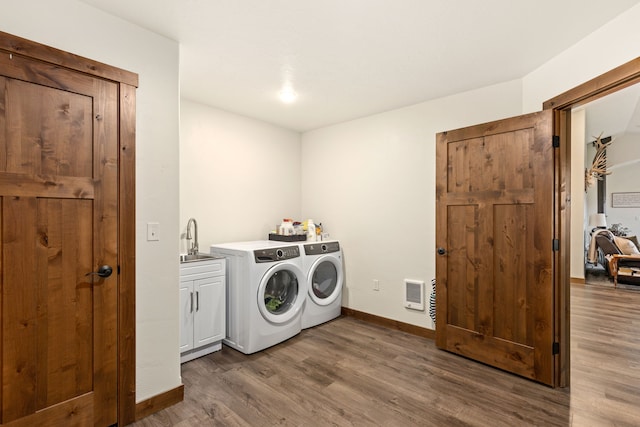 44 Kamloops Rd, Power, MT 59468 - laundry area featuring cabinet space, separate washer and dryer, dark wood-type flooring, and heating unit