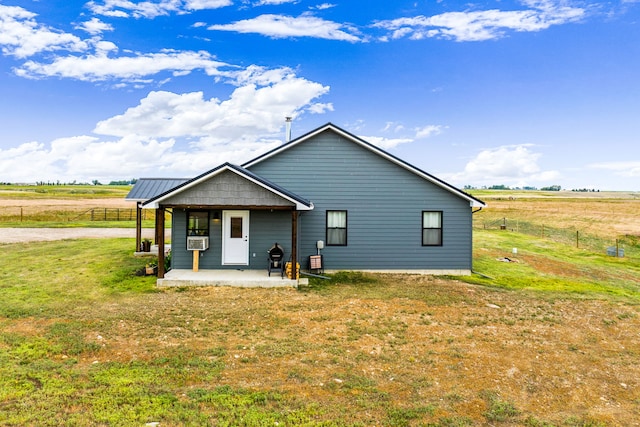 44 Kamloops Rd, Power, MT 59468 - rear view of house with cooling unit, a rural view, and a patio area