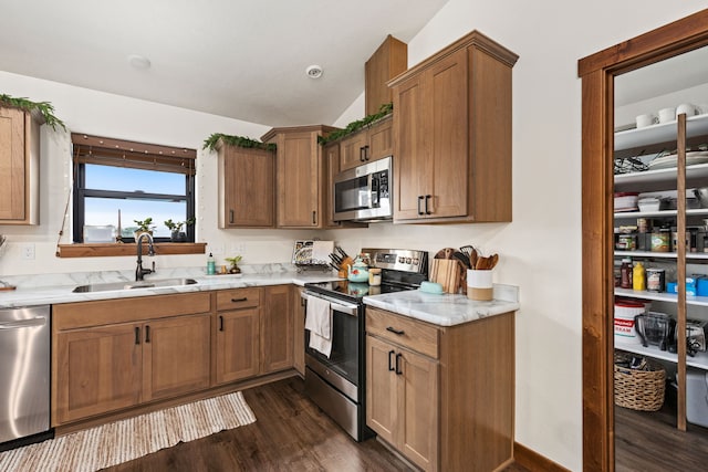 44 Kamloops Rd, Power, MT 59468 - kitchen featuring appliances with stainless steel finishes, dark wood-type flooring, brown cabinets, vaulted ceiling, and light stone counters