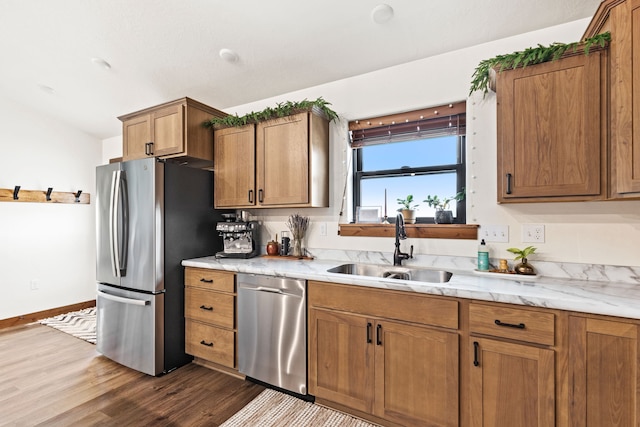 44 Kamloops Rd, Power, MT 59468 - kitchen featuring appliances with stainless steel finishes, dark wood-type flooring, brown cabinetry, and light stone countertops