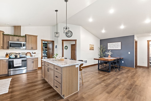 44 Kamloops Rd, Power, MT 59468 - kitchen featuring stainless steel appliances, a center island, dark wood-type flooring, a breakfast bar, and high vaulted ceiling