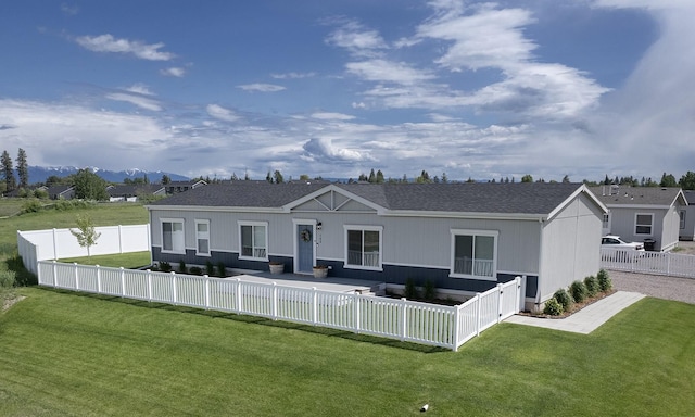 142 Otter Pl, Kalispell, MT 59901 - back of property featuring a fenced backyard and a shingled roof