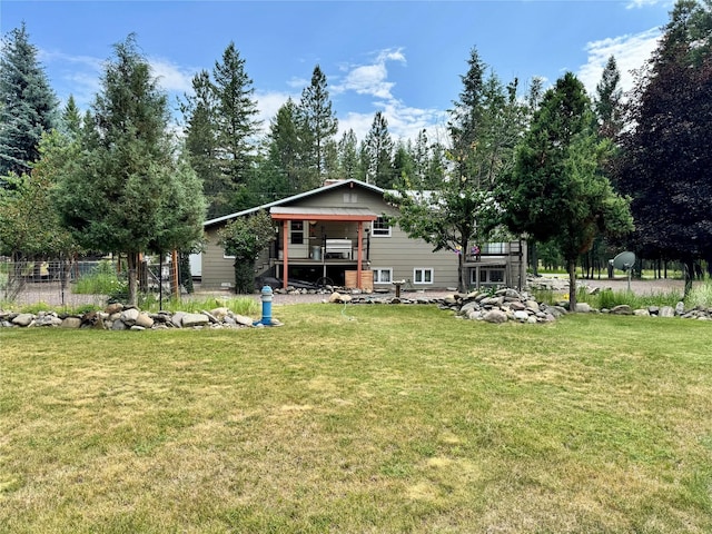676 Rawlings Rd, Libby, MT 59923 - rear view of property with a lawn