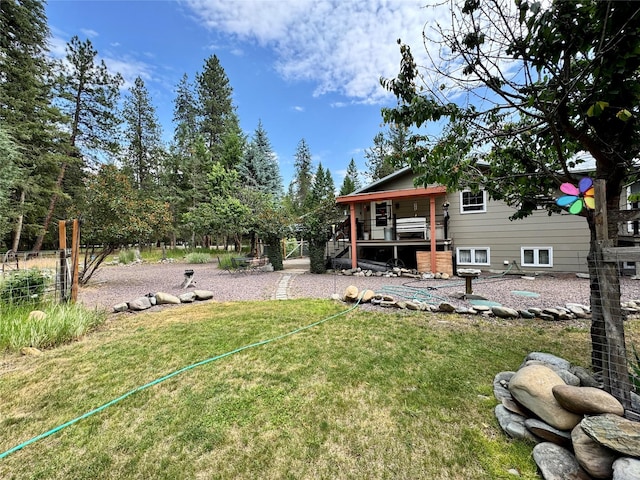 676 Rawlings Rd, Libby, MT 59923 - view of green lawn with a wooden deck