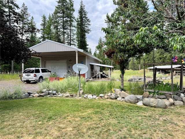 676 Rawlings Rd, Libby, MT 59923 - view of grassy yard featuring a garage