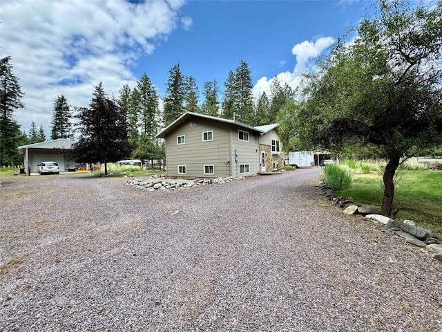 676 Rawlings Rd, Libby, MT 59923 - view of side of home featuring gravel driveway and a detached garage