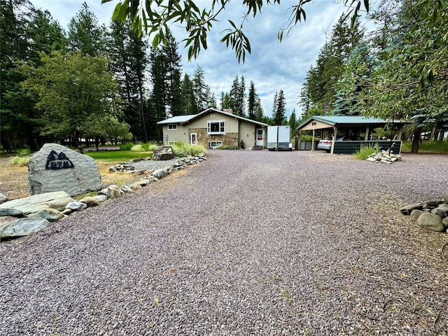 676 Rawlings Rd, Libby, MT 59923 - view of front of home featuring driveway and a chimney