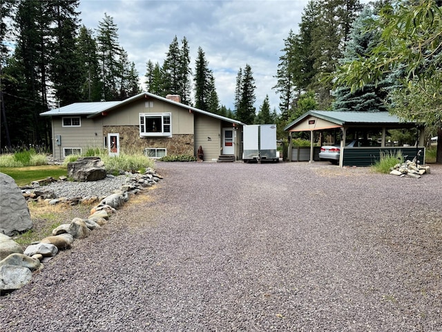 676 Rawlings Rd, Libby, MT 59923 - view of front of property featuring driveway, a chimney, and a carport