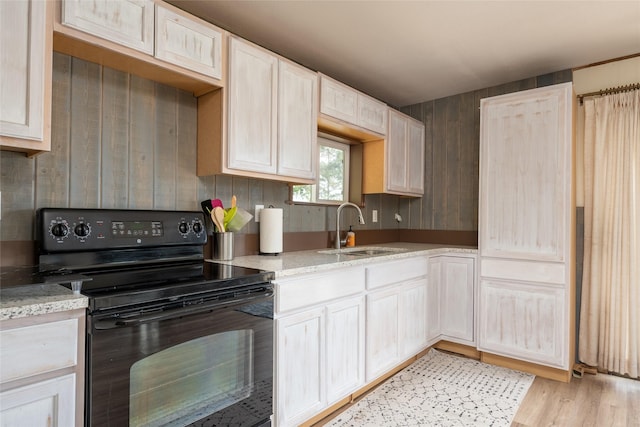 29276 White Swan Rd, Polson, MT 59860 - kitchen featuring black electric range, light wood-style floors, and light stone countertops